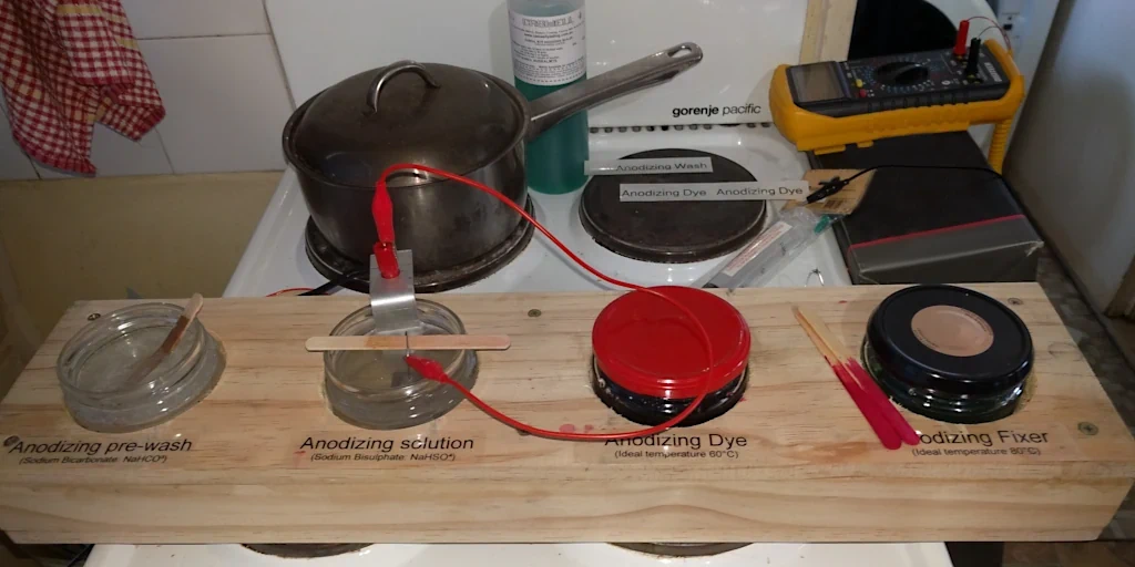 Anodizing station made of wood and glass pots.