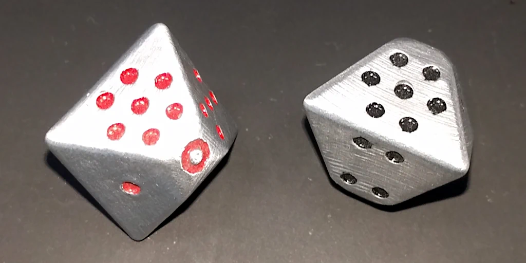Polished aluminium dice with dots hand-painted.